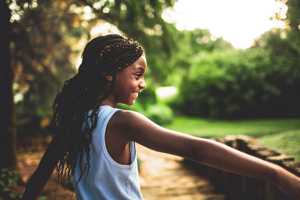 a child smiling in a park