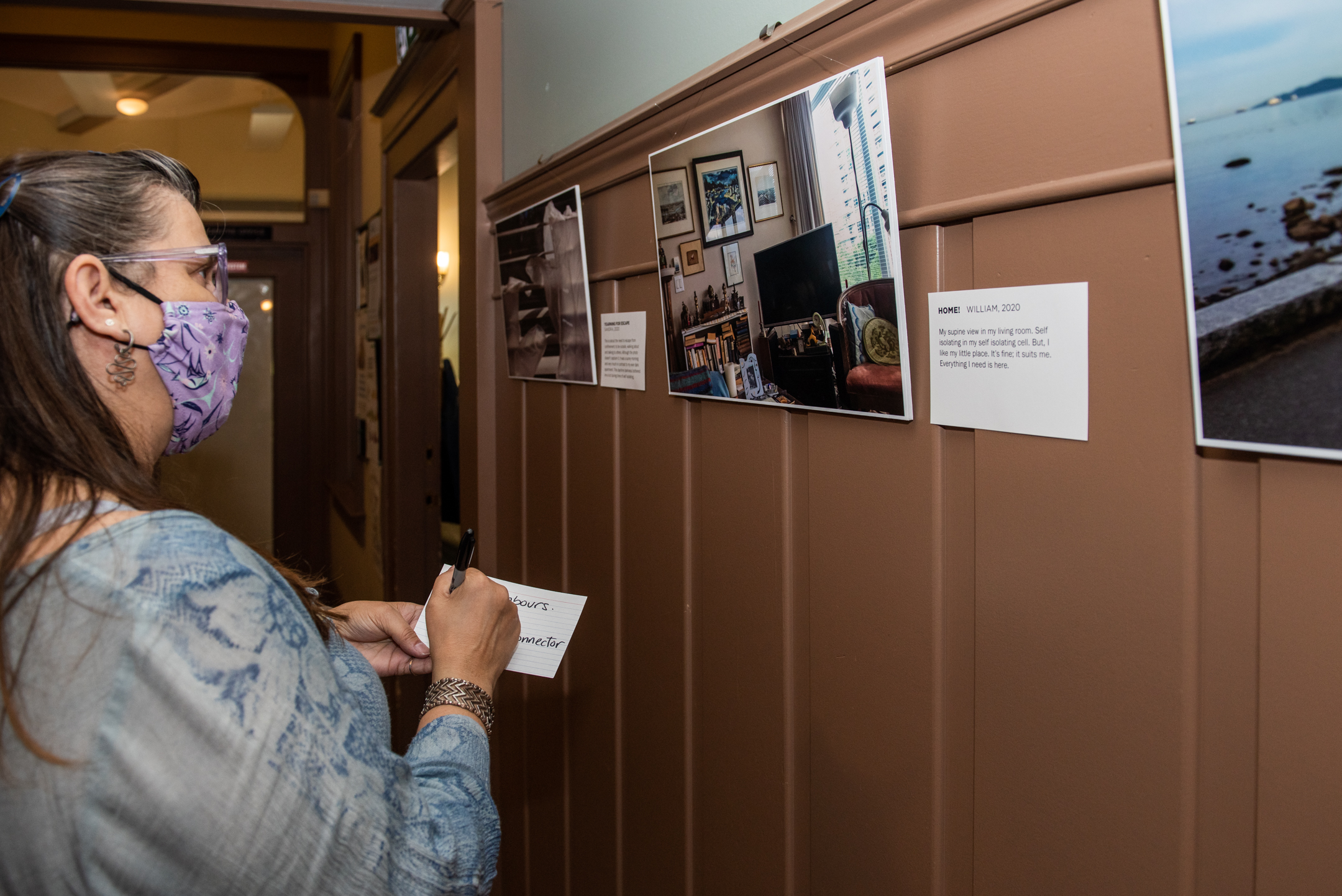 A participant with a selection of self-directed photos on display at the
Barclay Manor, September 2022.
